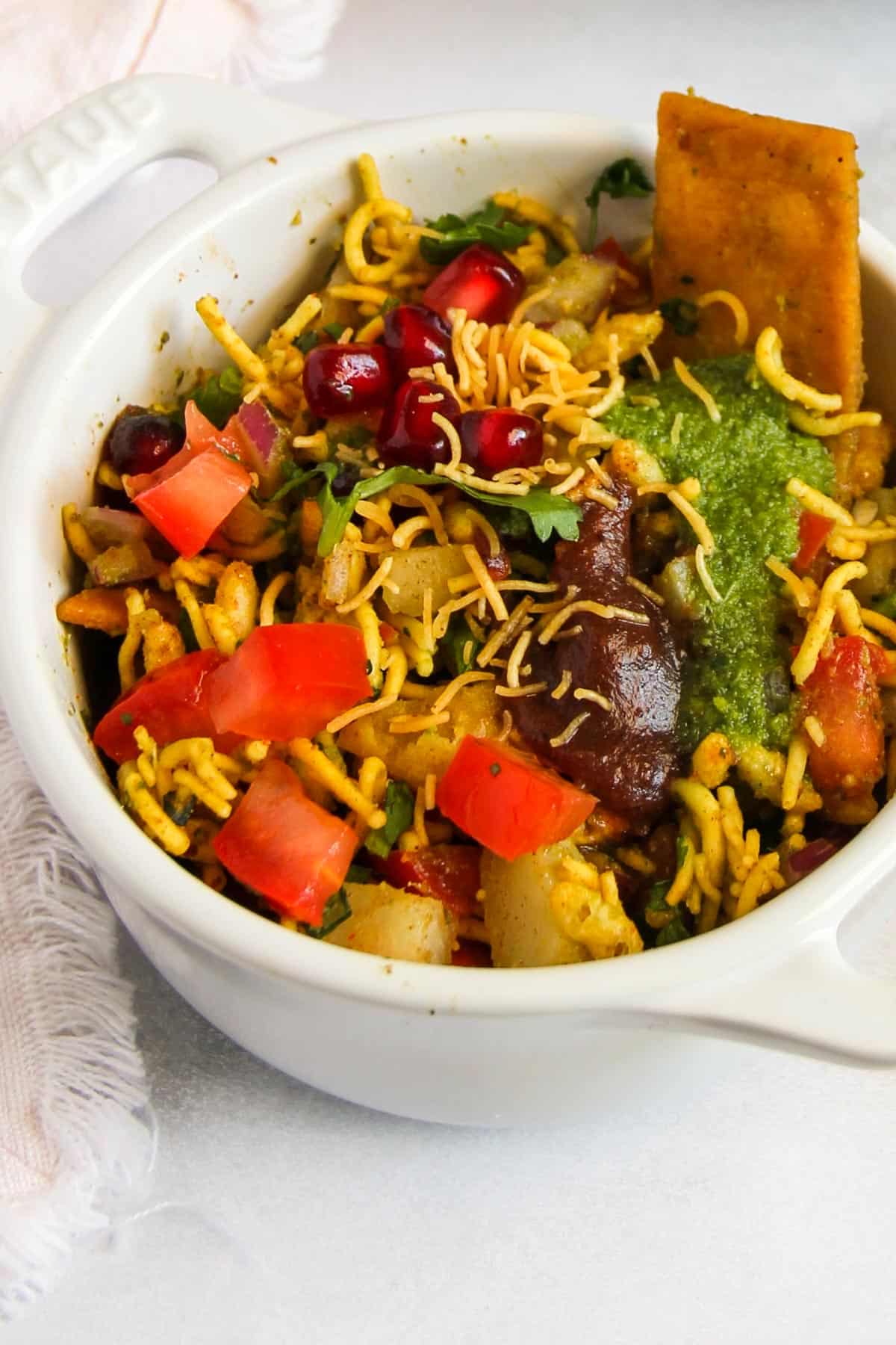 Bhel puri served in a white bowl 