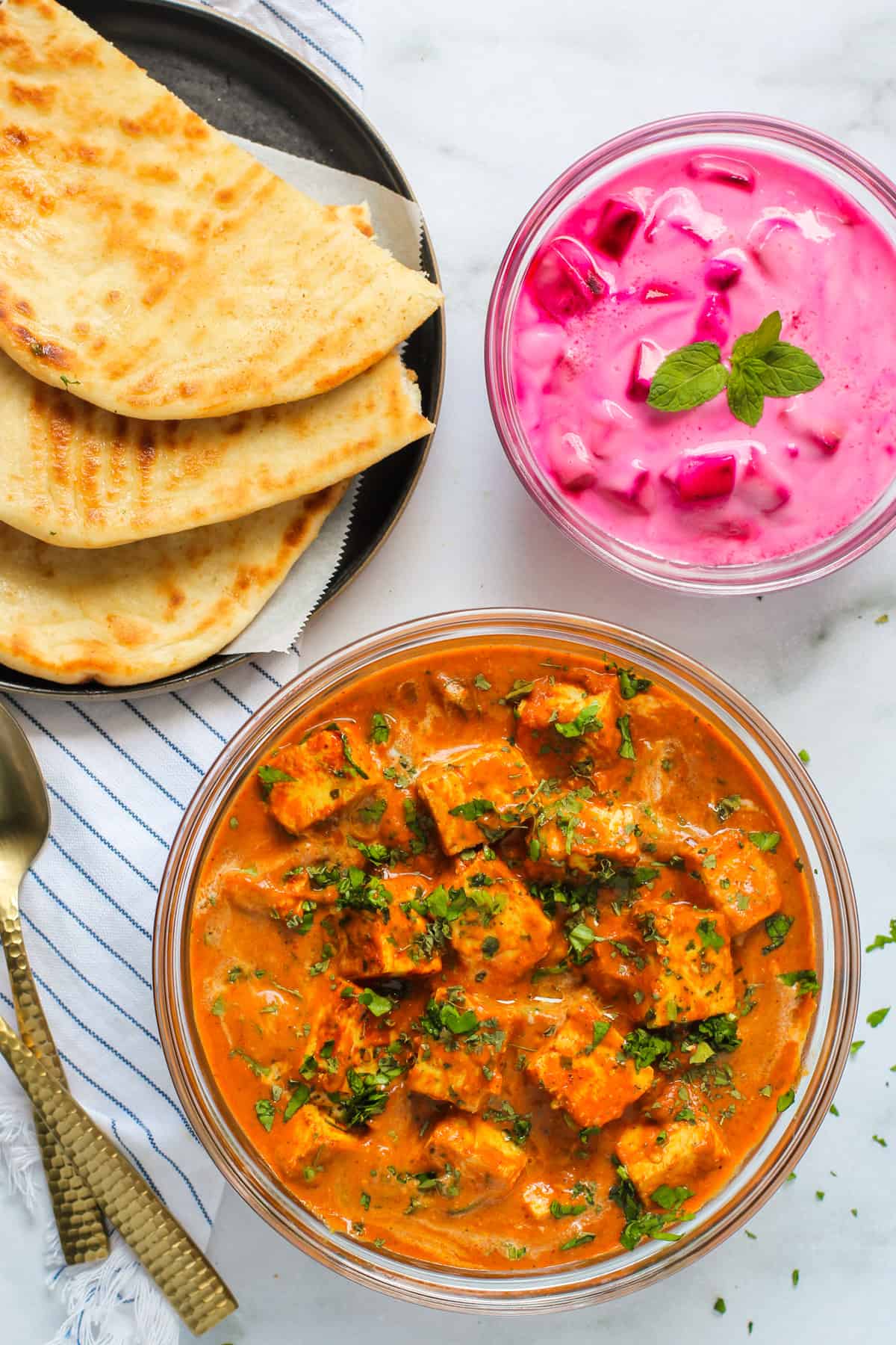 paneer butter masala served with naan and raita