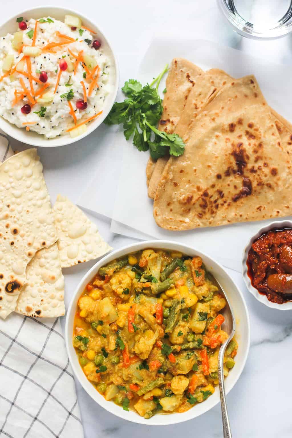 Veg Kurma served with parathas, rice and papad