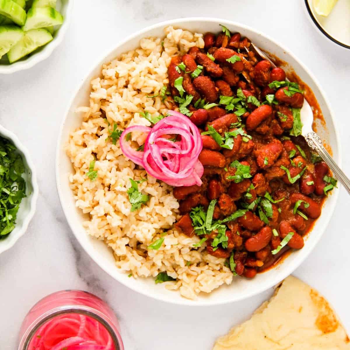 Rajma curry served with brown rice and pickled onions