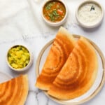 crispy dosa served with sambar, chutney and spicy potatoes