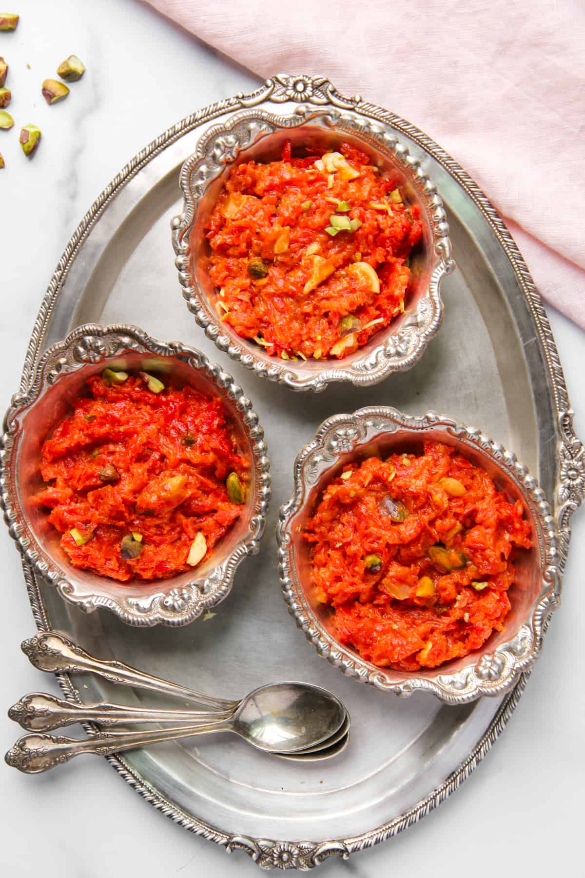 carrot halwa in three silver bowls 