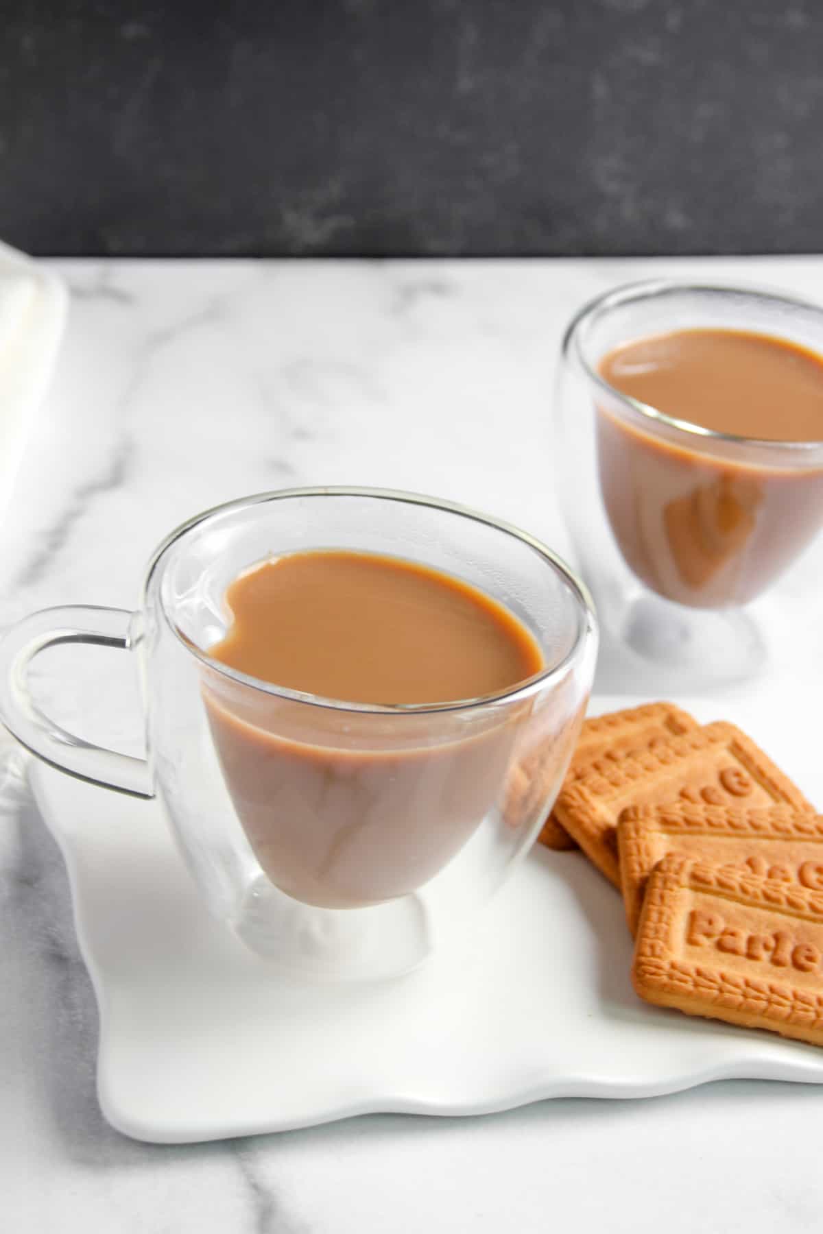 masala chai served with parle g biscuits 