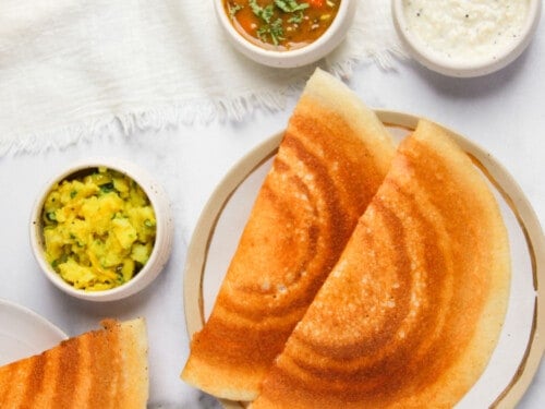 crispy dosa served with sambar, chutney and spicy potatoes