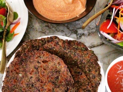 Purple Cabbbage Parathas in a platter with yogurt chutney and salad on the side