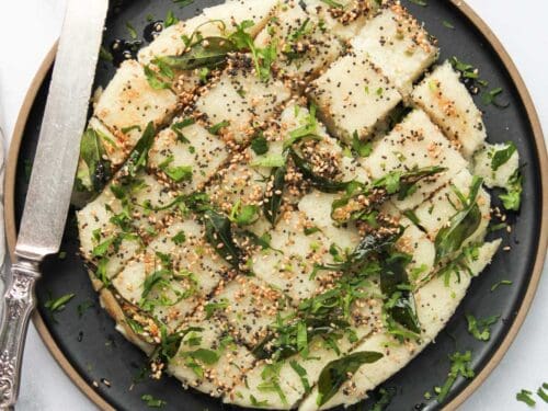 rava dhokla in a black platter