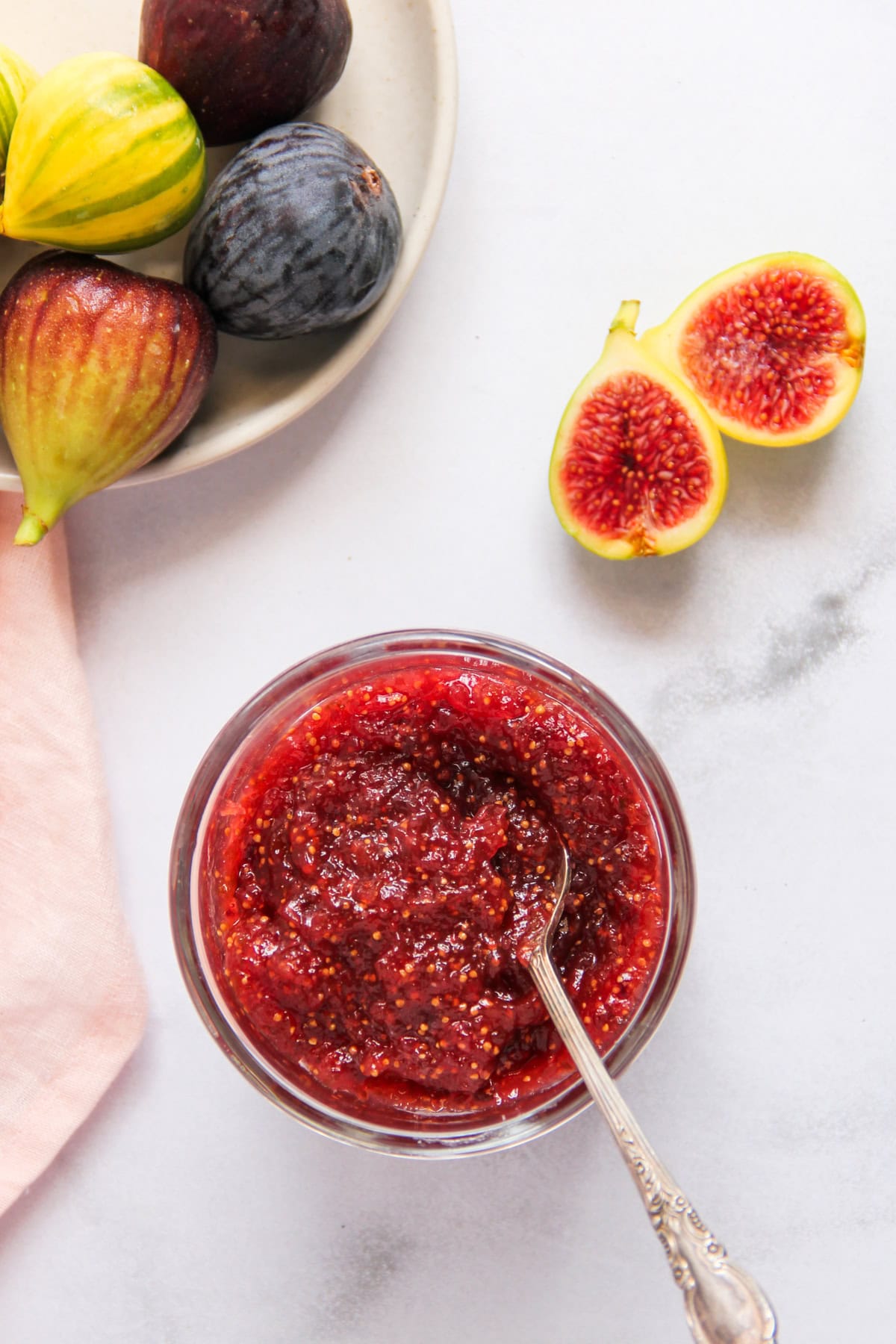 fig jam in a jar with fresh figs on the side 