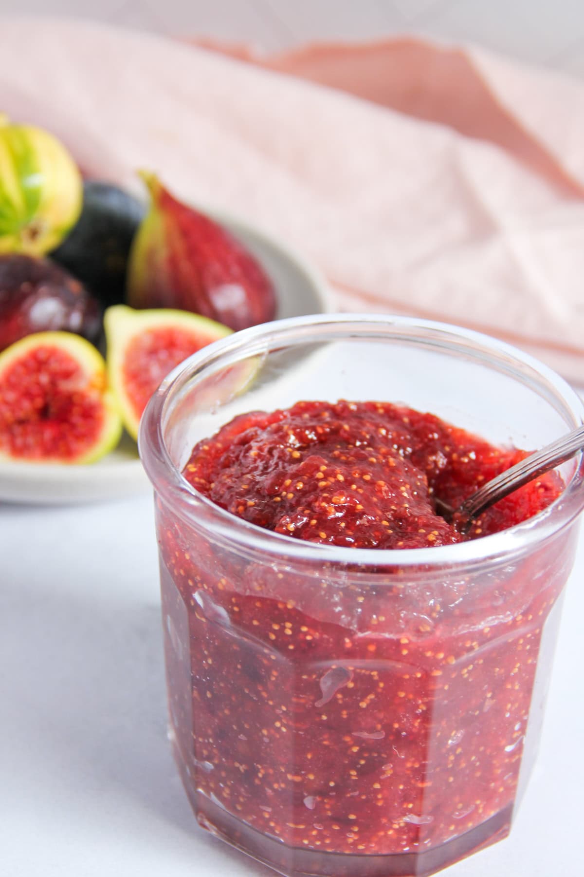 hoemmade fig jam in a jar with fresh figs on the side 