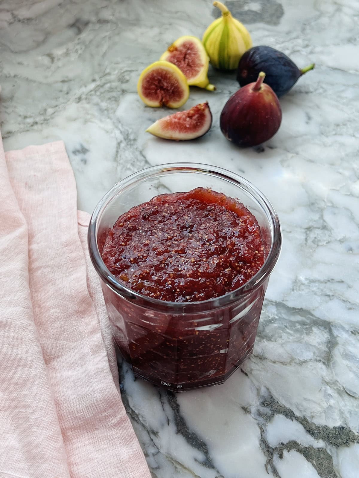 jar of fig jam with fresh figs on the side 