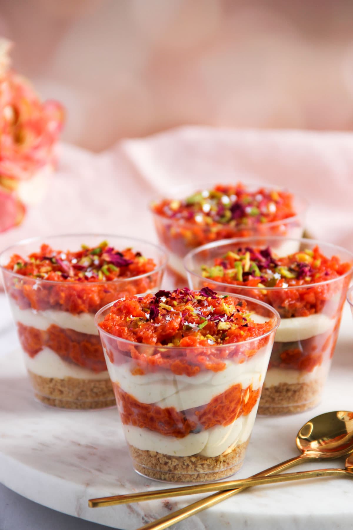 gajar halwa cheesecake jars garnished with rose petals and edible stars 