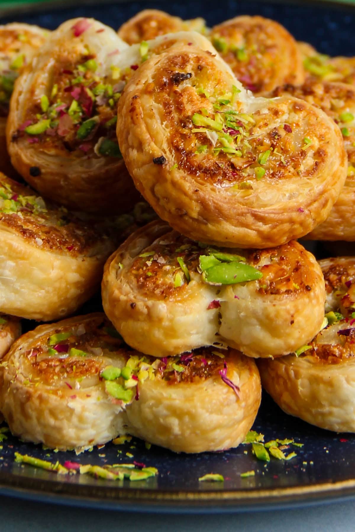 close up of gujiya hearts garnished with nuts.