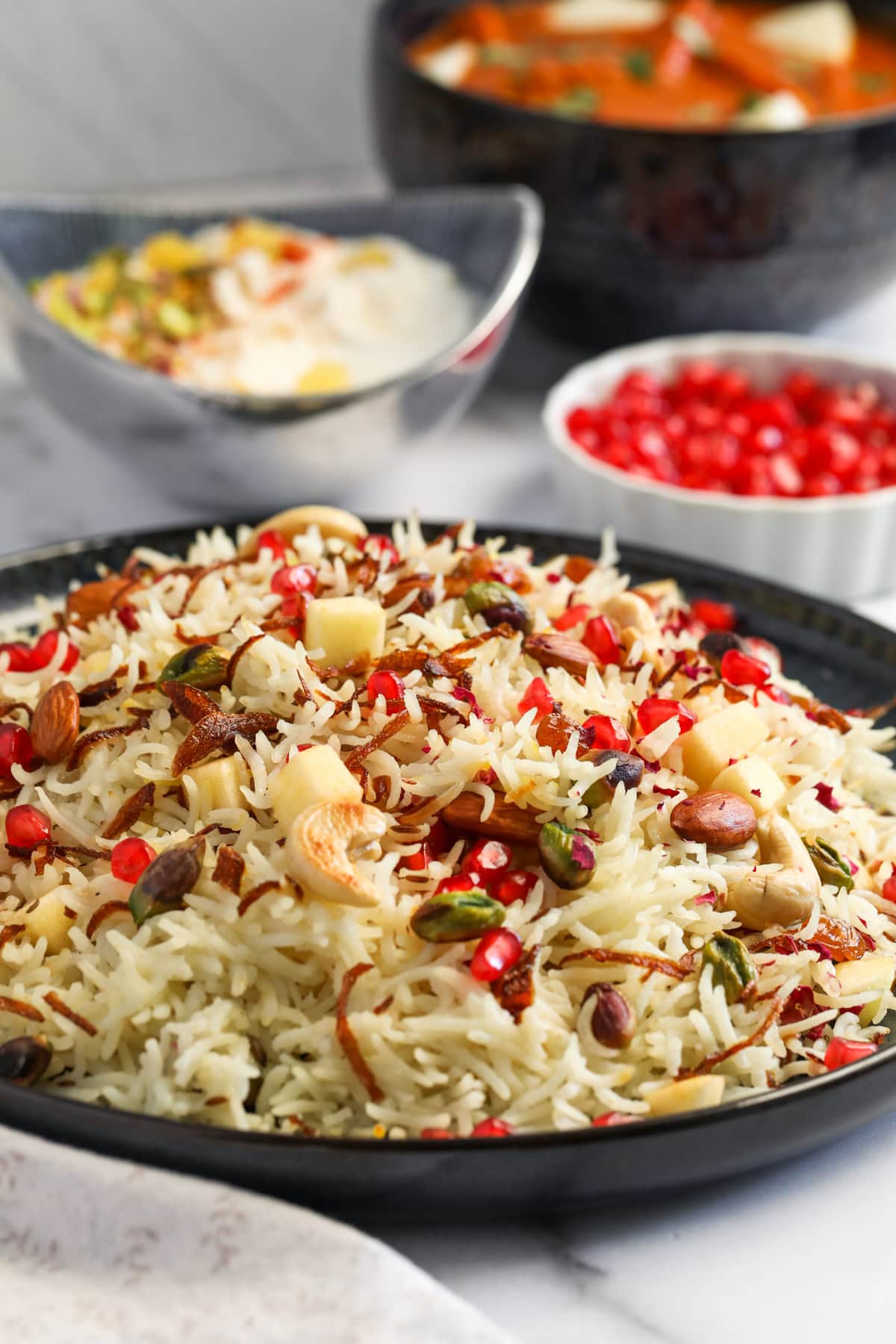 Kashmiri Pulao served with raita and paneer makhani 