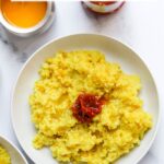 Pinterest Pin a photo of plain khichdi served with pickle and ghee.