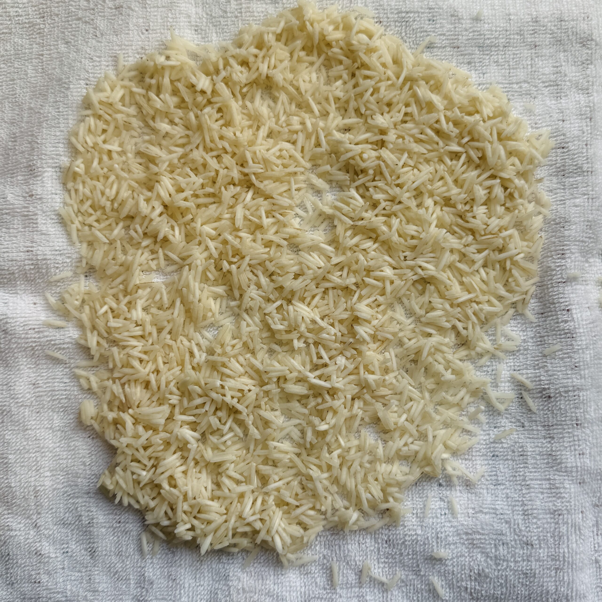 rinsed rice drying on kitchen towel 