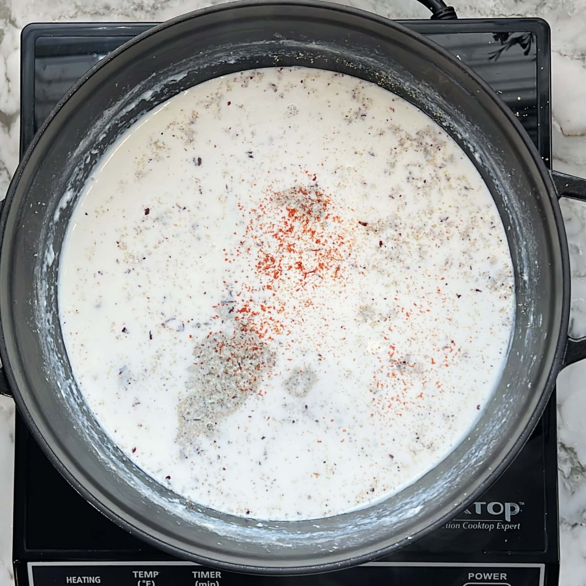 Thandai masala and saffron added to milk